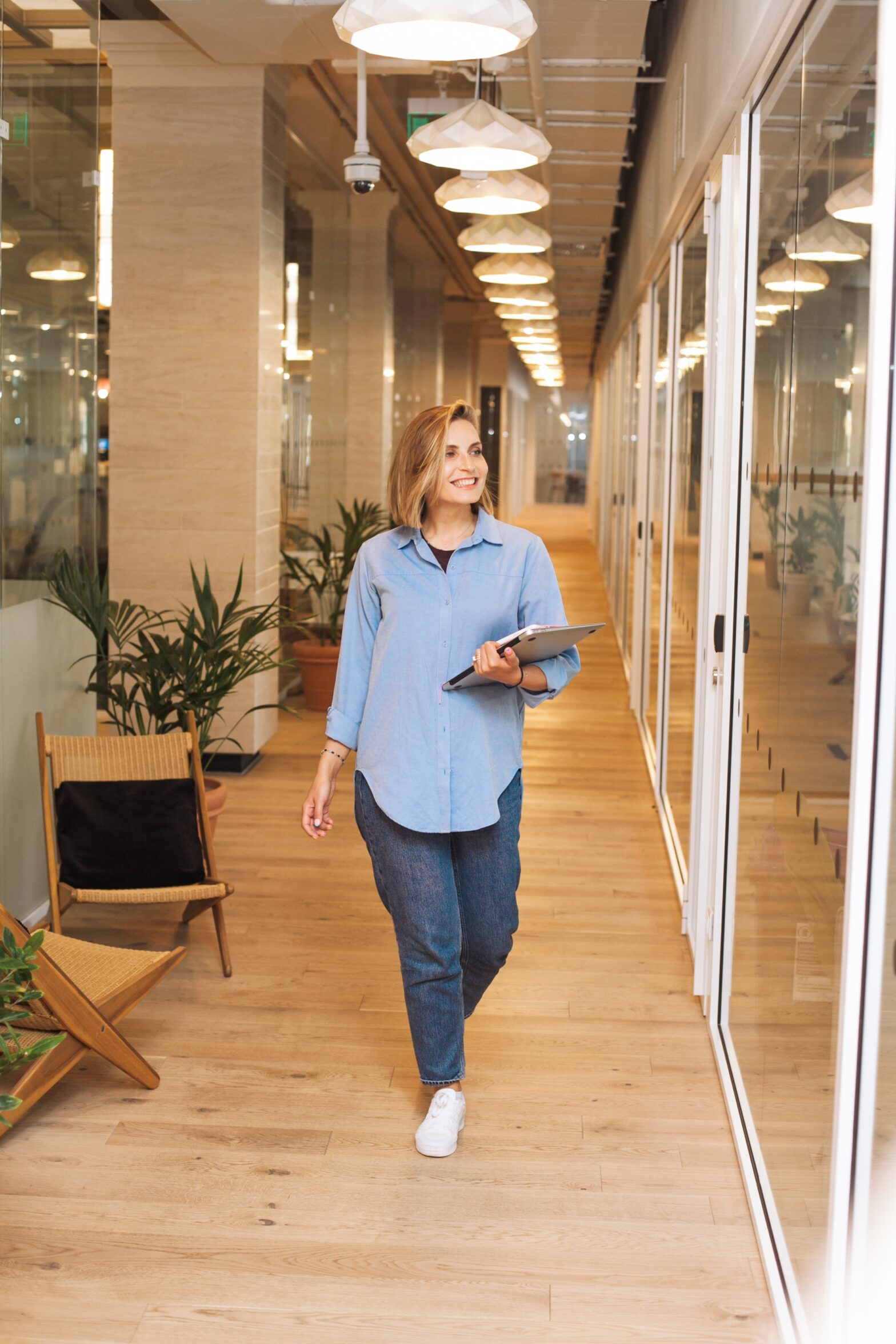 Woman walking along office corridor